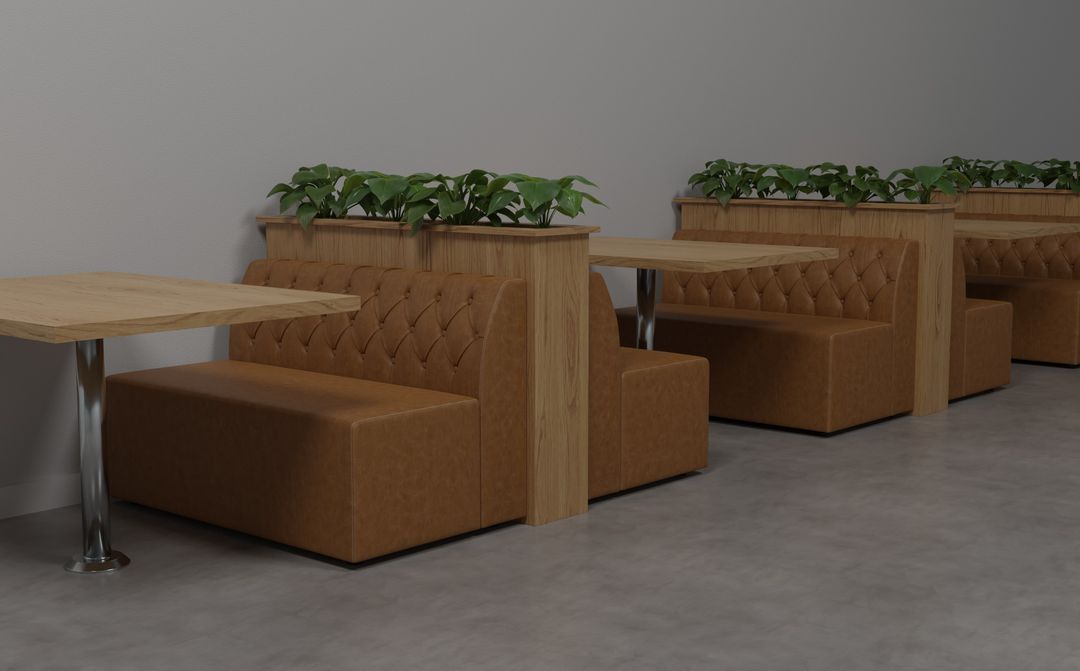 Tan tufted restaurant booth banquettes with tables and planter dividers